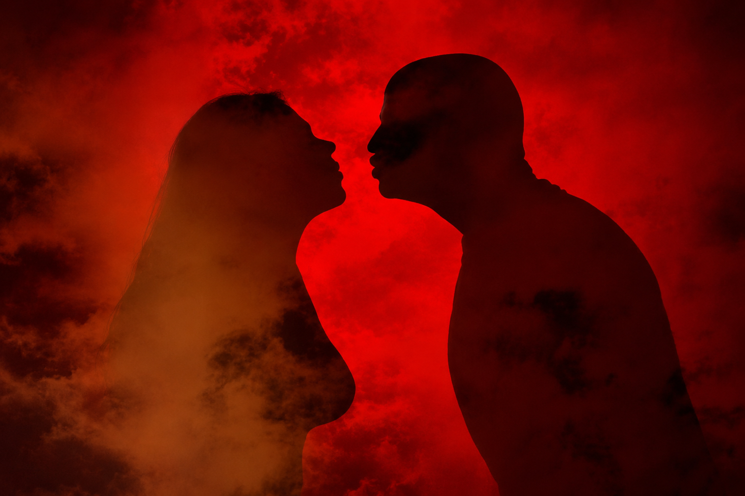 Silhouettes of a man and woman facing each other against a red background