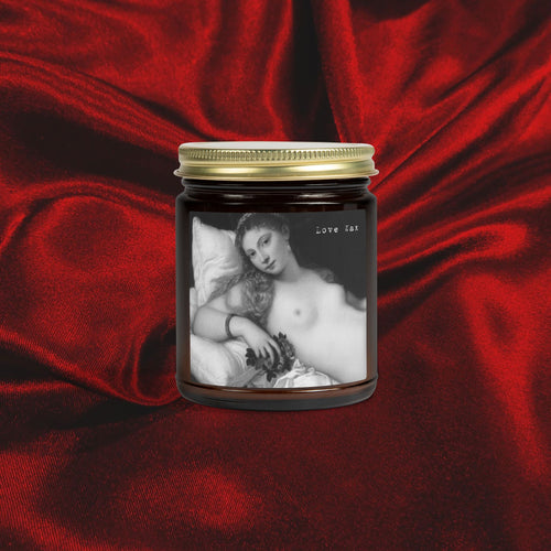 Candle jar with a black and white image of a woman on a red fabric background