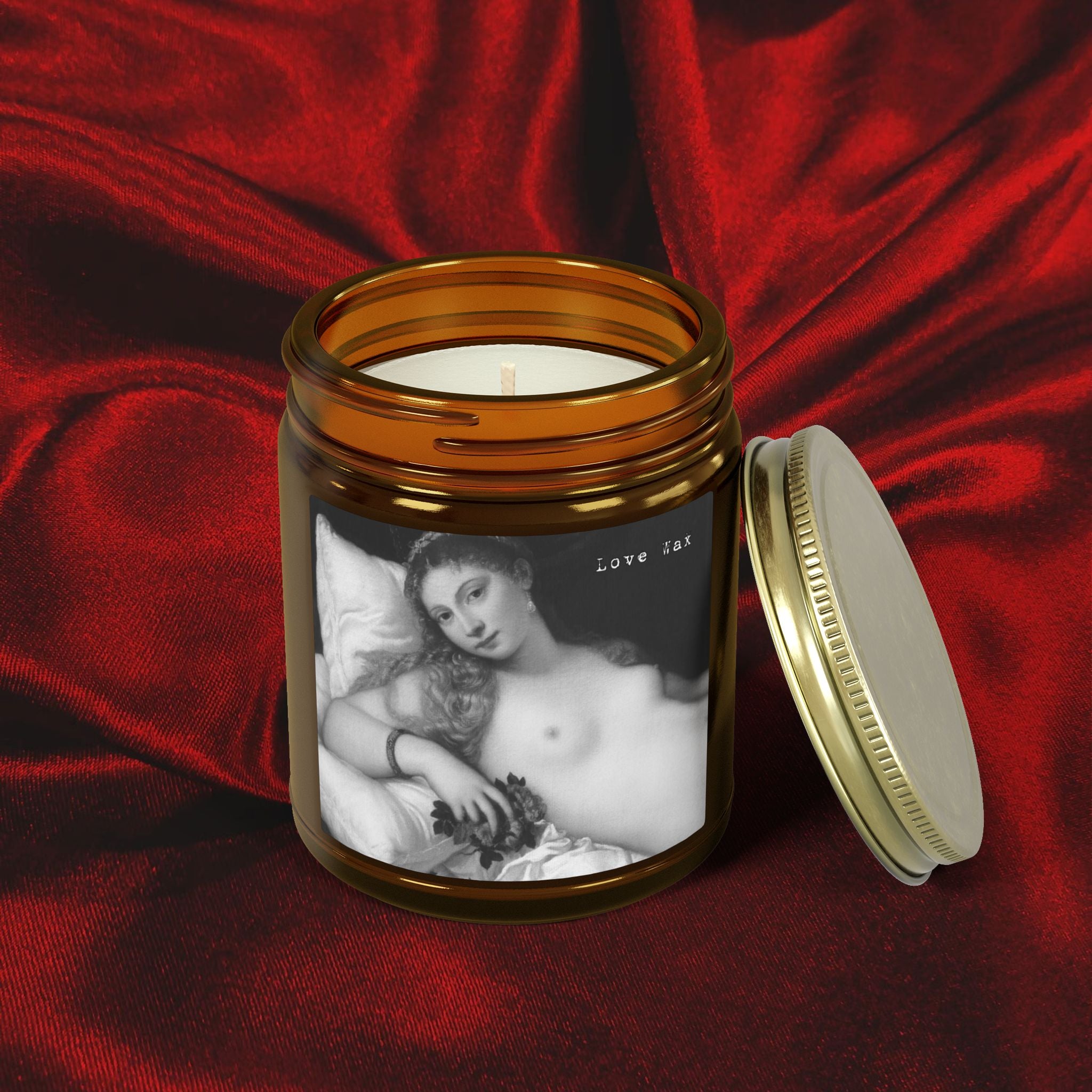 Candle in a jar with a printed design on a red fabric background